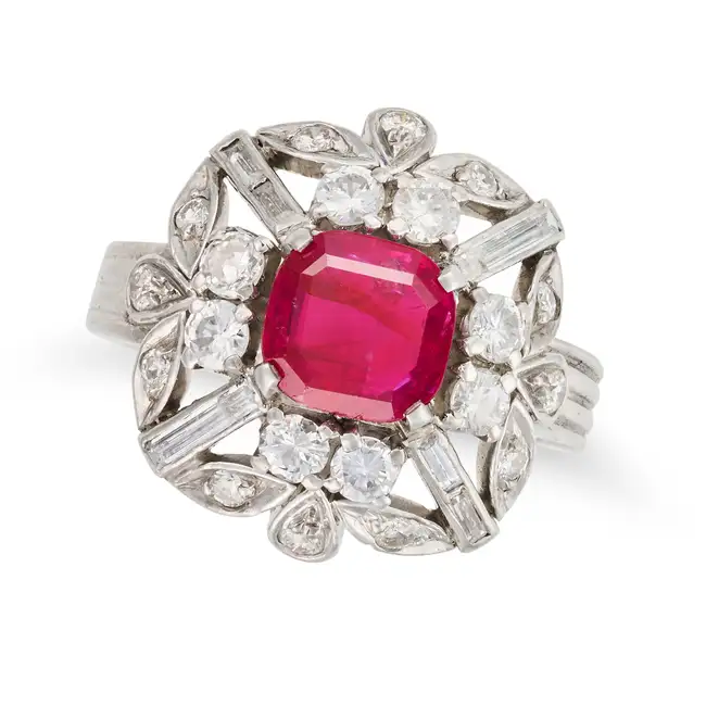 A RUBY AND DIAMOND DRESS RING set with a mixed cut ruby of approximately 1.88 carats, accented by