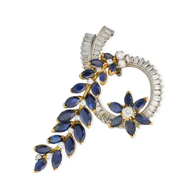 A VINTAGE SAPPHIRE AND DIAMOND BROOCH the scrolling brooch in foliate design, set with marquise