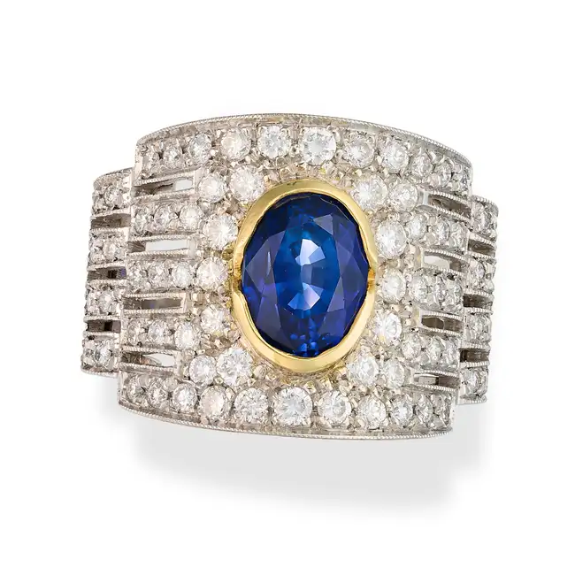 A SAPPHIRE AND DIAMOND DRESS RING set with an oval cut sapphire of approximately 2.40 carats,