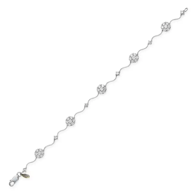 A DIAMOND BRACELET comprising clusters of round brilliant cut diamonds and round brilliant cut