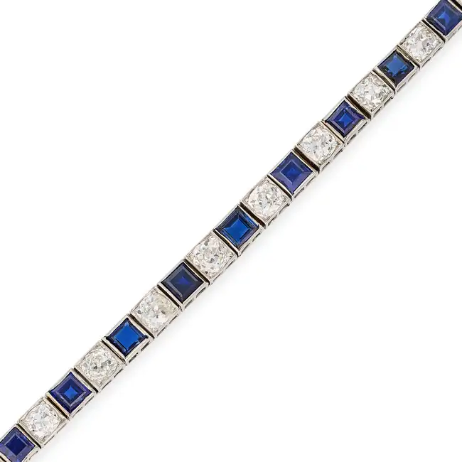 AN ART DECO SAPPHIRE AND DIAMOND LINE BRACELET comprising a row of alternating square step cut
