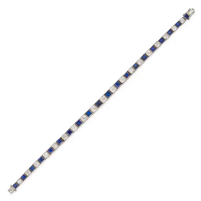 AN ART DECO SAPPHIRE AND DIAMOND LINE BRACELET comprising a row of alternating square step cut