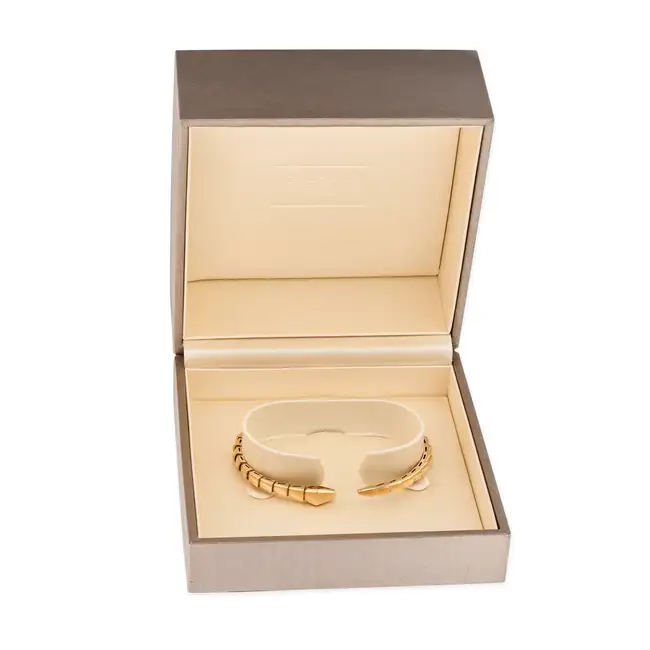 BULGARI, A GOLD SERPENTI VIPER BANGLE in 18ct yellow gold, the articulated bangle designed as a