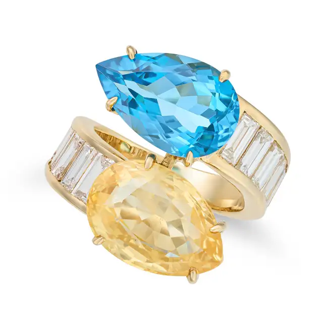 TADINI, A YELLOW SAPPHIRE, BLUE TOPAZ AND DIAMOND CROSSOVER RING in crossover design, set at each