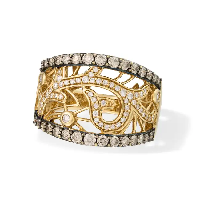 A DIAMOND DRESS RING in 14ct yellow gold, the openwork ring in foliate design, set with round