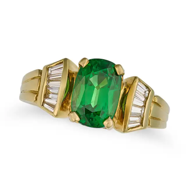 A TSAVORITE GARNET AND DIAMOND DRESS RING set with a cushion cut tsavorite garnet of approximately