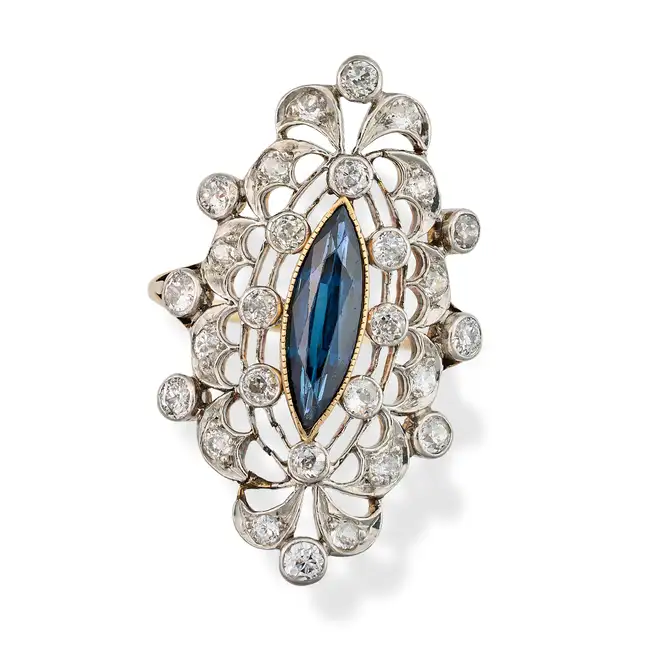 AN ANTIQUE SAPPHIRE AND DIAMOND DRESS RING, EARLY 20TH CENTURY set with a marquise cut sapphire, the