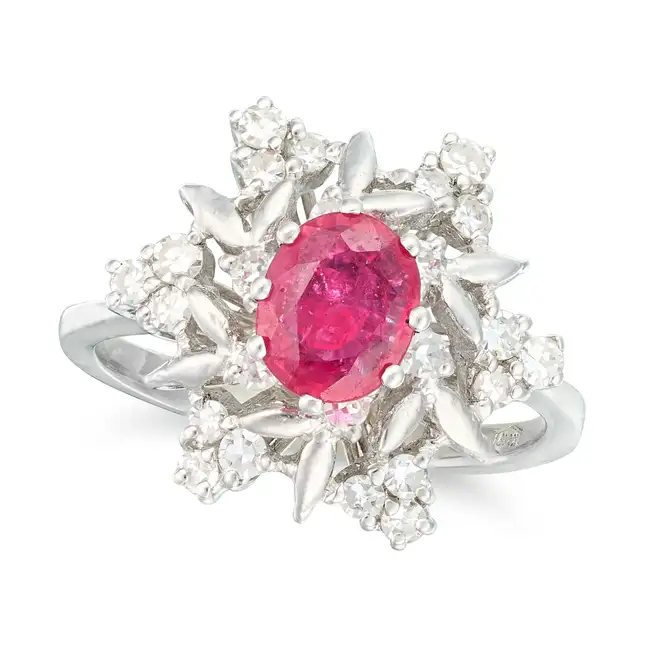 A RUBY AND DIAMOND DRESS RING set with an oval cut ruby of approximately 0.76 carats, within a