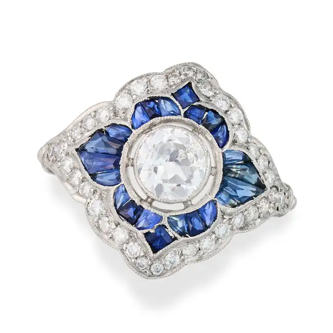 A DIAMOND AND SAPPHIRE RING set with an old cut diamond of approximately 0.50 carats in a border