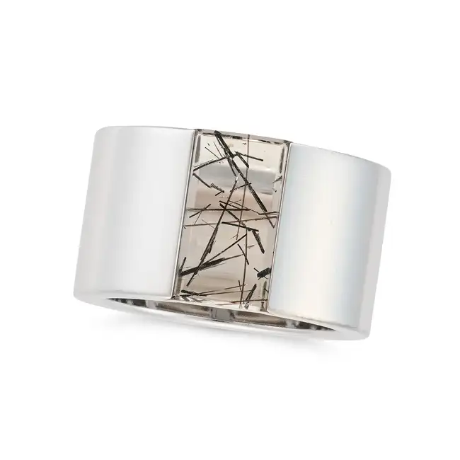 CARTIER, A RUTILATED QUARTZ TANK RING, 1999 in 18ct white gold, the wide band set with polished