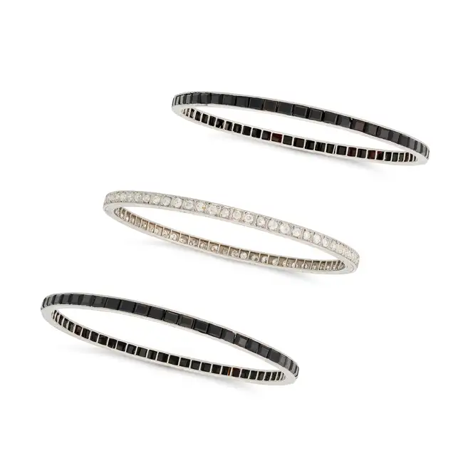 THREE ART DECO ONYX AND DIAMOND BANGLES, EARLY 20TH CENTURY one set all around with a row of old