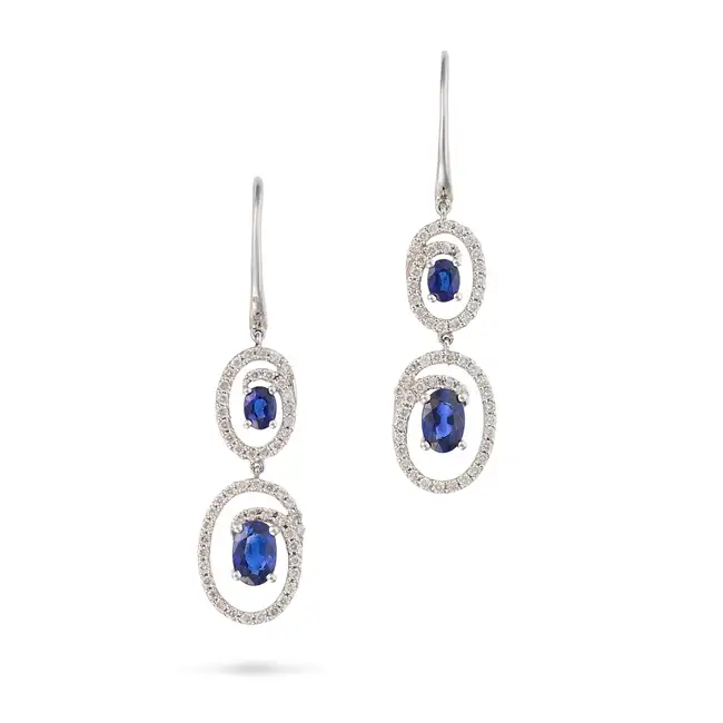 A PAIR OF SAPPHIRE AND DIAMOND DROP EARRINGS each set with two oval cut sapphires in swirling frames