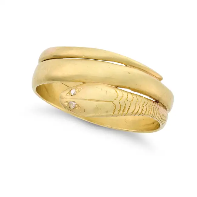AN ANTIQUE GOLD SNAKE RING in yellow gold, designed as a coiled snake, the eyes set with rose cut