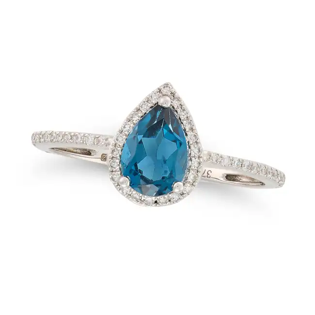 NO RESERVE - A TOPAZ AND DIAMOND CLUSTER RING in 9ct white gold, set with a pear cut blue topaz in a