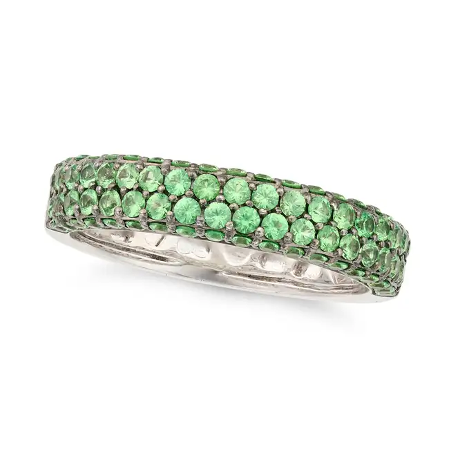 A TSAVORITE GARNET BAND RING in 18ct white gold, the band set half way around with round cut