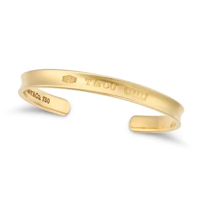 TIFFANY & CO., A GOLD 1837 CUFF BANGLE the open cuff engraved T&CO 1837, signed Tiffany & Co.