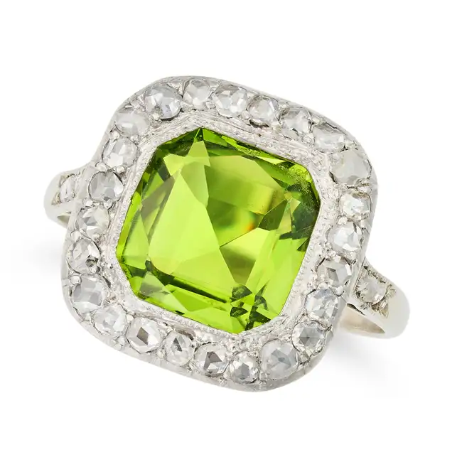 AN ART DECO PERIDOT AND DIAMOND DRESS RING set with an octagonal mixed cut peridot of