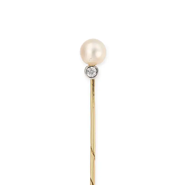 AN ANTIQUE AUSTRIAN PEARL AND DIAMOND STICK / TIE PIN in yellow gold, set with a pearl accented by
