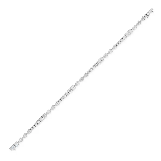 A FINE DIAMOND BRACELET set with graduating round brilliant cut diamonds and trios of pear brilliant
