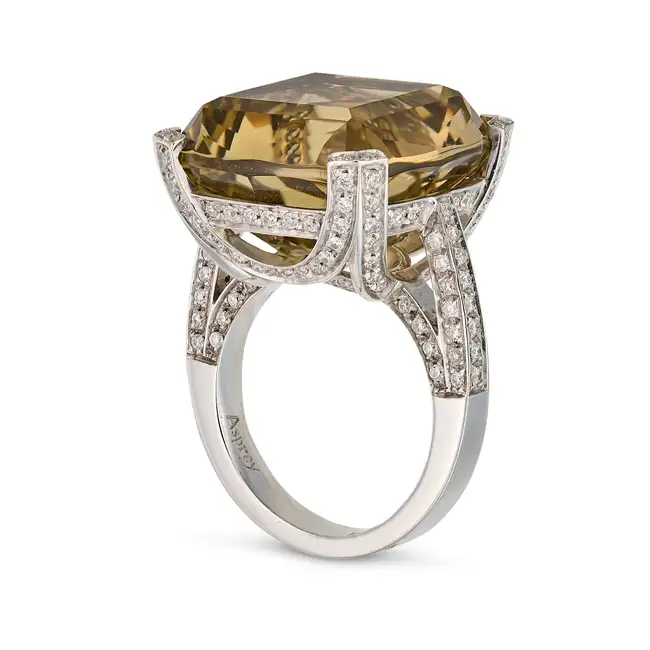 ASPREY, A CITRINE AND DIAMOND DRESS RING set with a cushion cut citrine of approximately 25.00