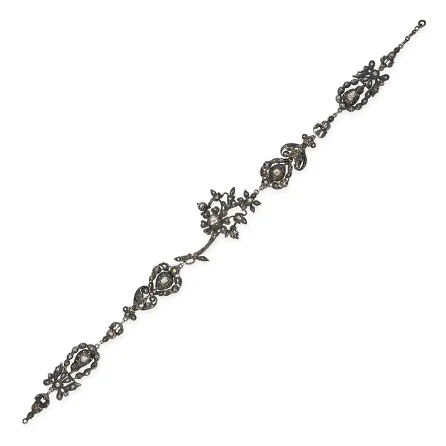 AN ANTIQUE GEORGIAN DIAMOND JEWEL in silver, comprising a row of five foliate motifs set with rose
