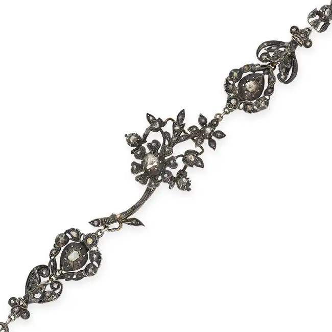 AN ANTIQUE GEORGIAN DIAMOND JEWEL in silver, comprising a row of five foliate motifs set with rose