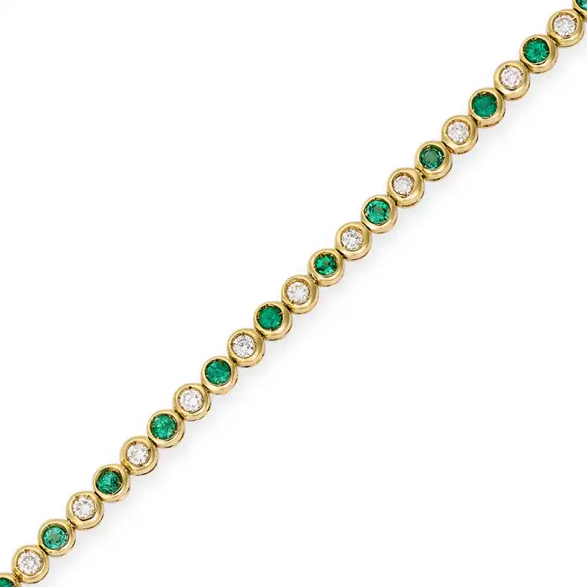 AN EMERALD AND DIAMOND LINE BRACELET in 18ct yellow gold, comprising a row of alternating round