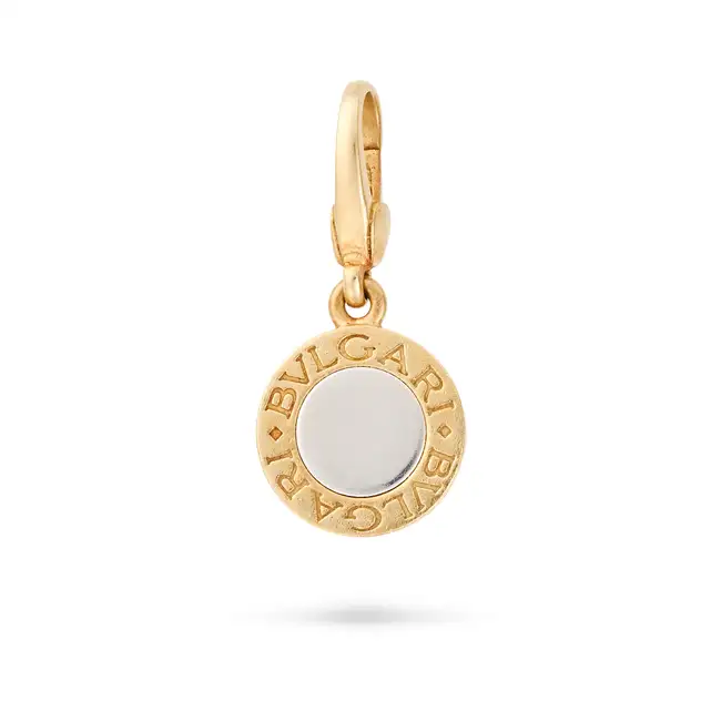 NO RESERVE - BULGARI, A BVLGARI BVLGARI CHARM / PENDANT in 18ct yellow gold and white gold, the