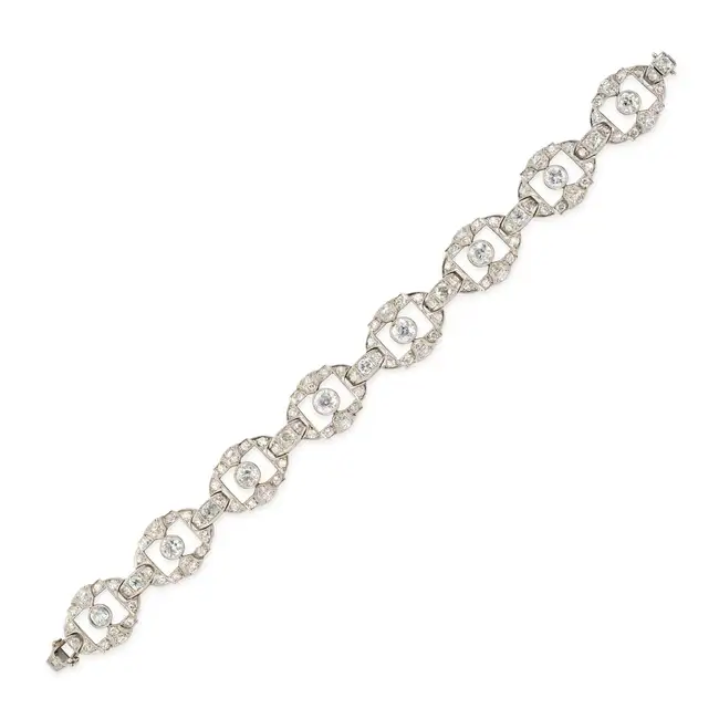 A FINE ART DECO DIAMOND BRACELET in platinum, comprising a series of openwork geometric links set