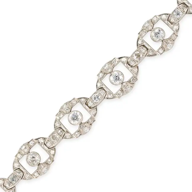 A FINE ART DECO DIAMOND BRACELET in platinum, comprising a series of openwork geometric links set