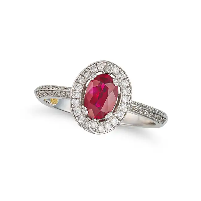 A RUBY AND DIAMOND DRESS RING in 18ct white gold, set with an oval cut ruby of approximately 0.83