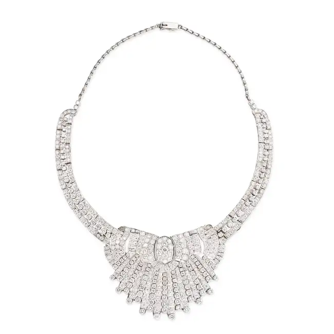 A DIAMOND COLLAR NECKLACE in silver, the stylised scrolling necklace set throughout with round