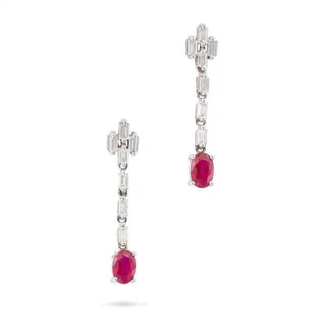 A PAIR OF RUBY AND DIAMOND DROP EARRINGS in 18ct white gold, each comprising a row of baguette cut