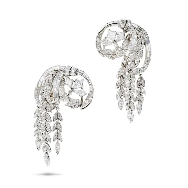 A FINE PAIR OF VINTAGE DIAMOND DROP CLIP EARRINGS in scrolling foliate design, each set with