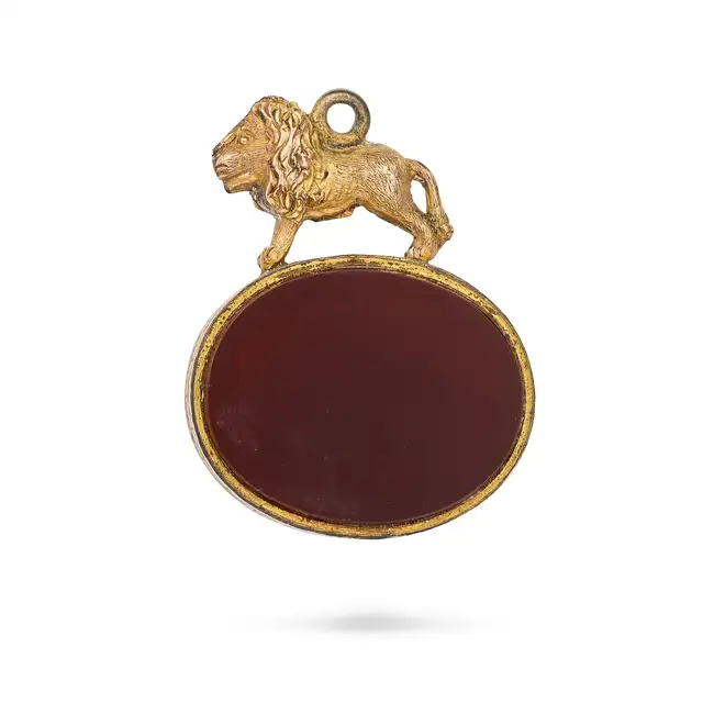NO RESERVE - THREE ANTIQUE PENDANTS comprising a pendant set with a hessonite garnet, accented by