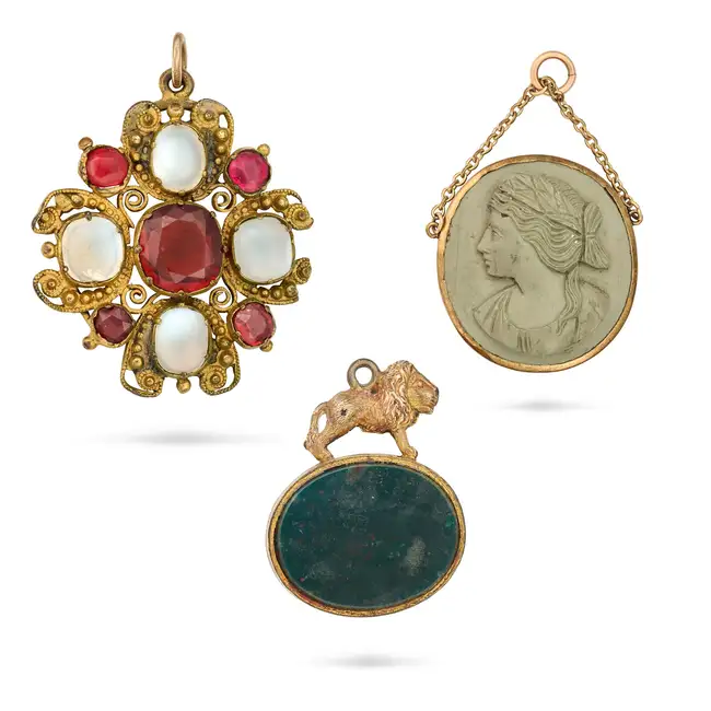 NO RESERVE - THREE ANTIQUE PENDANTS comprising a pendant set with a hessonite garnet, accented by