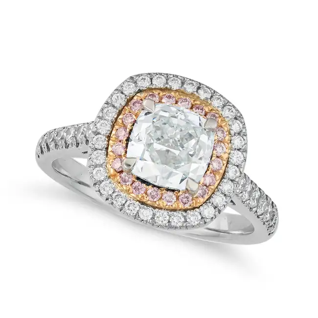A 1.34 CARAT VERY LIGHT BLUE AND PINK DIAMOND DRESS RING in platinum, set with a cushion cut very