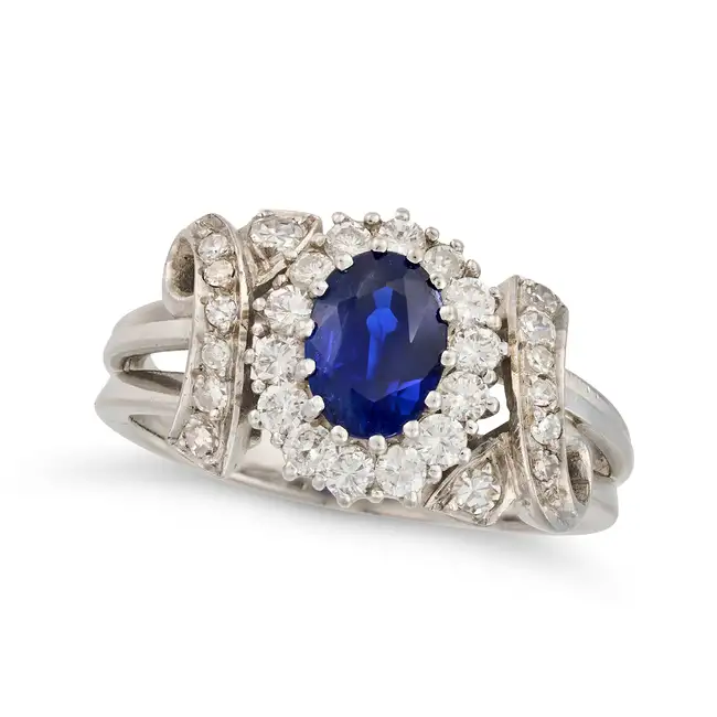 NO RESERVE - A BURMA NO HEAT SAPPHIRE AND DIAMOND RING set with an oval cut sapphire of 0.90