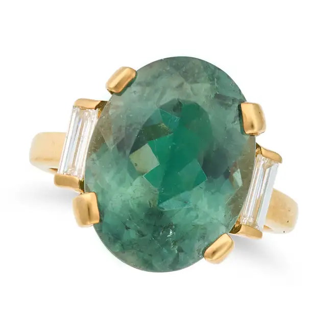 A LAGOON GREEN-BLUE TOURMALINE AND DIAMOND RING in yellow gold, set with an oval cut lagoon