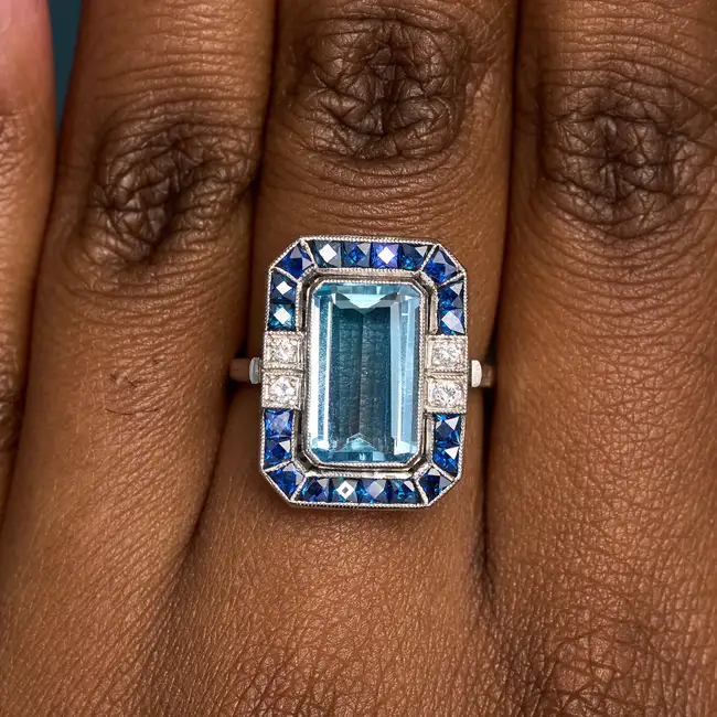 A FINE AQUAMARINE, SAPPHIRE AND DIAMOND DRESS RING set with an octagonal step cut aquamarine of