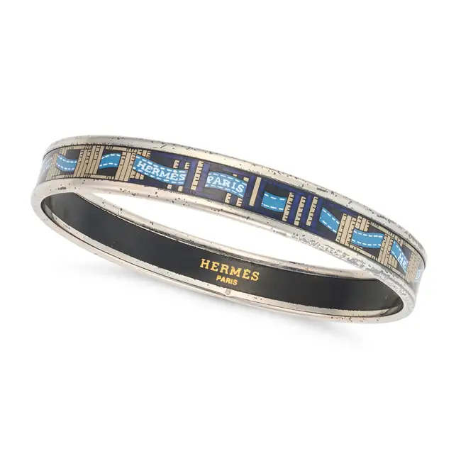 NO RESERVE - HERMES, AN ENAMEL BANGLE the bangle designed with a scrolling blue Hemres Paris ribbon,