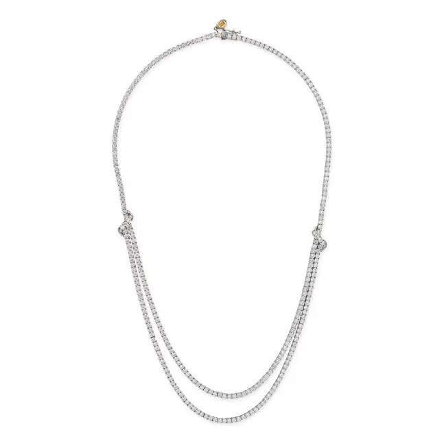 A DIAMOND NECKLACE in 18ct white gold, set with a row of round brilliant cut diamonds, leading to