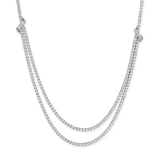 A DIAMOND NECKLACE in 18ct white gold, set with a row of round brilliant cut diamonds, leading to