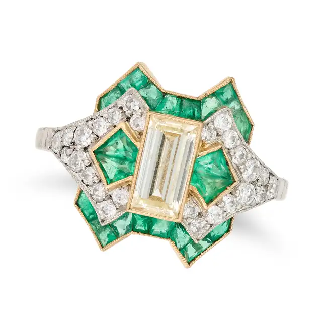 AN ART DECO EMERALD AND DIAMOND DRESS RING set with a baguette cut diamond of approximately 1.27