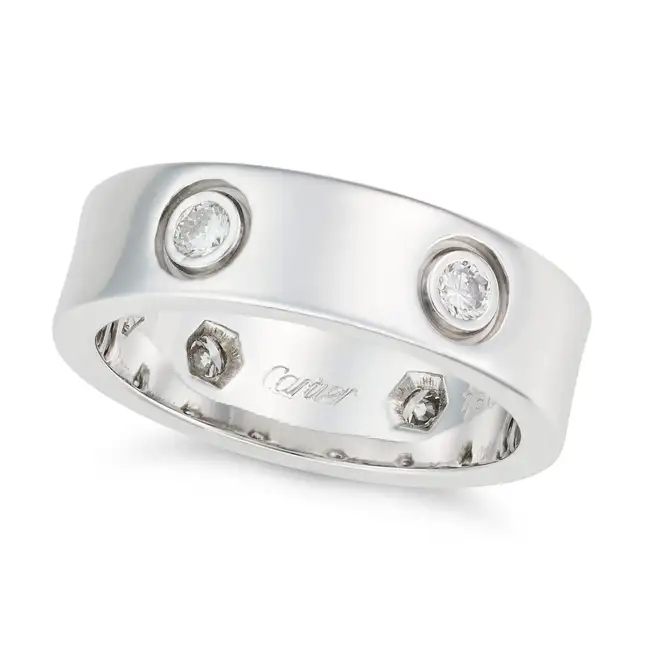 CARTIER, A DIAMOND LOVE RING the band punctuated by six screw head motifs set with six round