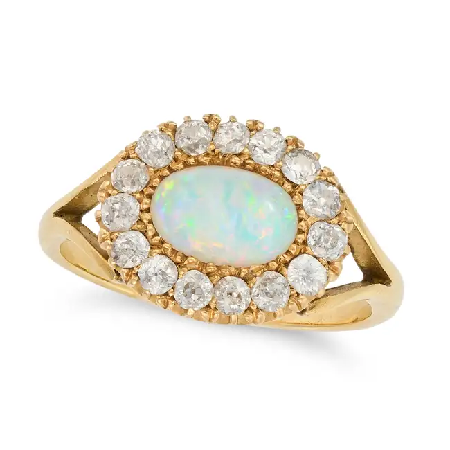 AN ANTIQUE OPAL AND DIAMOND CLUSTER RING set with an oval cabochon opal within a cluster of old