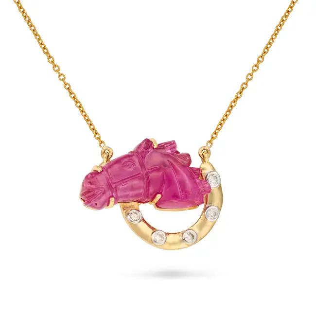 A CARVED RUBY AND DIAMOND HORSE AND HORSESHOE PENDANT NECKLACE the pendant set with a carved ruby