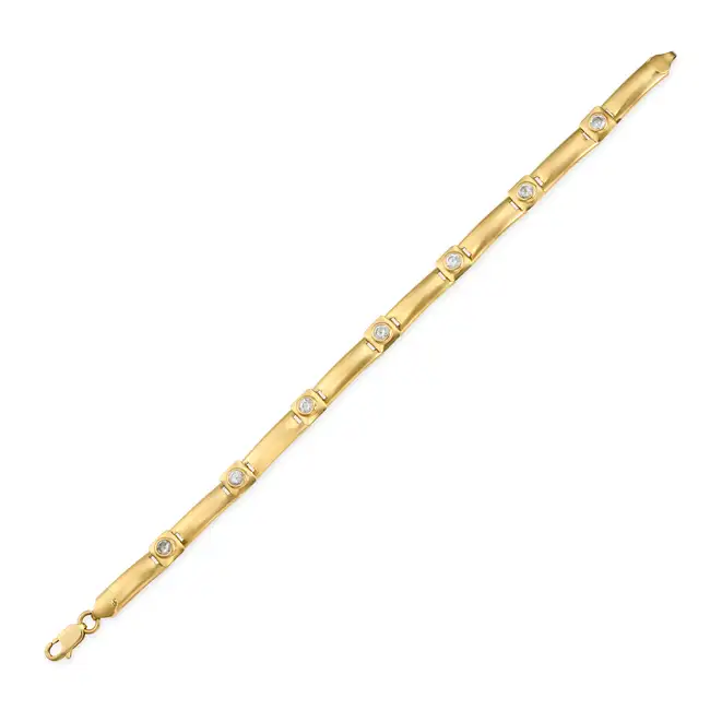 A GOLD BRACELET comprising a row of square and rectangular links, the square links set with round