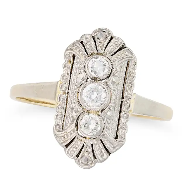 A DIAMOND DRESS RING in Art Deco design, the geometric face set with a trio of round brilliant cut