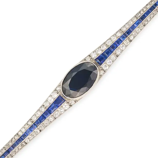 ATTR. MAUBOUSSIN, AN ART DECO SAPPHIRE AND DIAMOND BRACELET set with an oval cut sapphire of